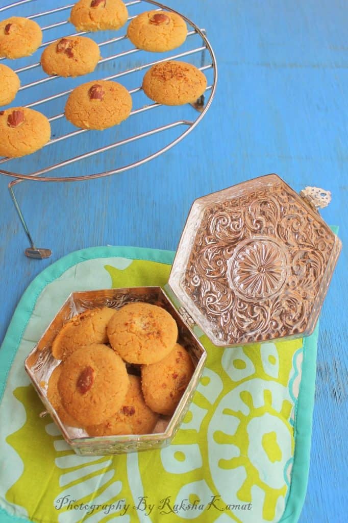 Indian chai and Nankhatai cookies on a tray, perfect tea-time snack setting.
