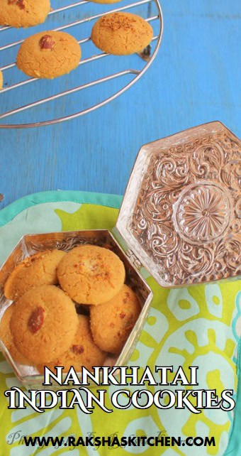 Close-up of eggless Nankhatai cookies topped with almonds on a cooling rack.