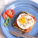 Open toast with fried egg tomato and spinach