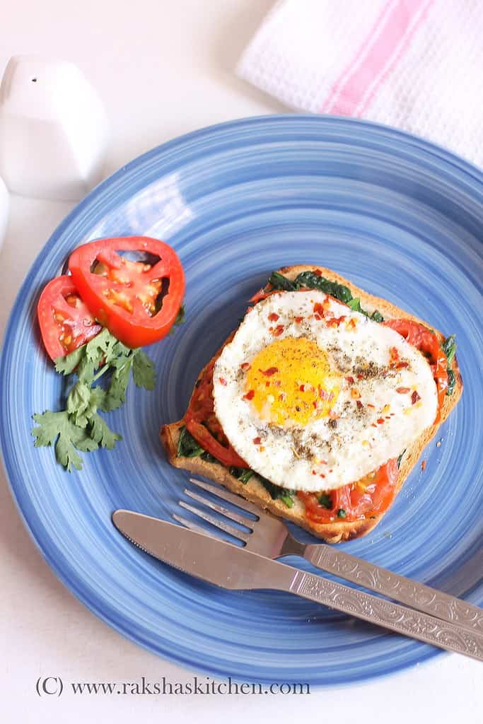 Open toast with fried egg tomato and spinach