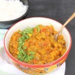 Aromatic Persian Eggplant Stew (Khoresht Bademjan) made with tomatoes, spices, and sautéed eggplant. This classic Iranian stew is served with rice and is completely plant-based! Save this easy vegan Persian dinner idea for later!