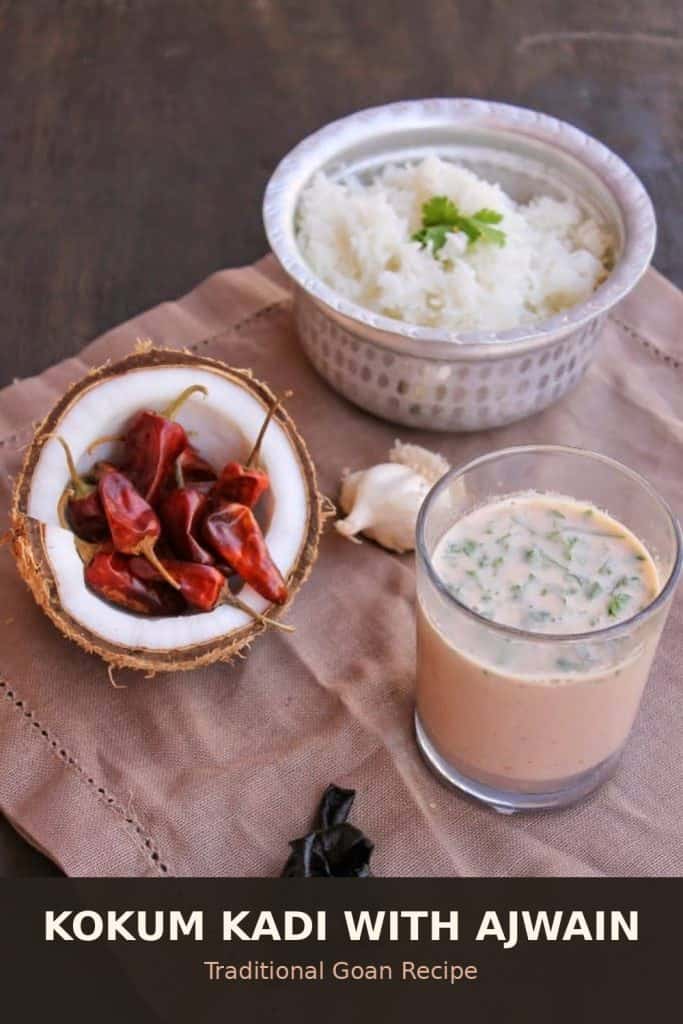 Traditional Goan kokum kadi with ajwain, dried red chilies, garlic and coconut shell on a table with rice