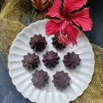 Chocolate Rava Modaks served on a festive plate as prasad for Ganesh Chaturthi.