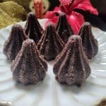 Close-up of chocolate rava mixture being filled into a modak mould.