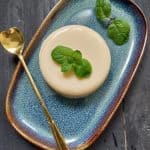 Chilled tender coconut pudding in a ramekin garnished with mint leaves.