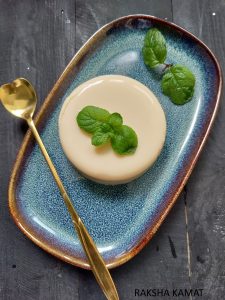 Chilled tender coconut pudding in a ramekin garnished with mint leaves.