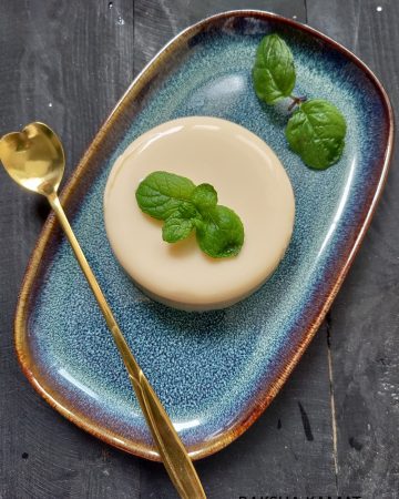 Chilled tender coconut pudding in a ramekin garnished with mint leaves.